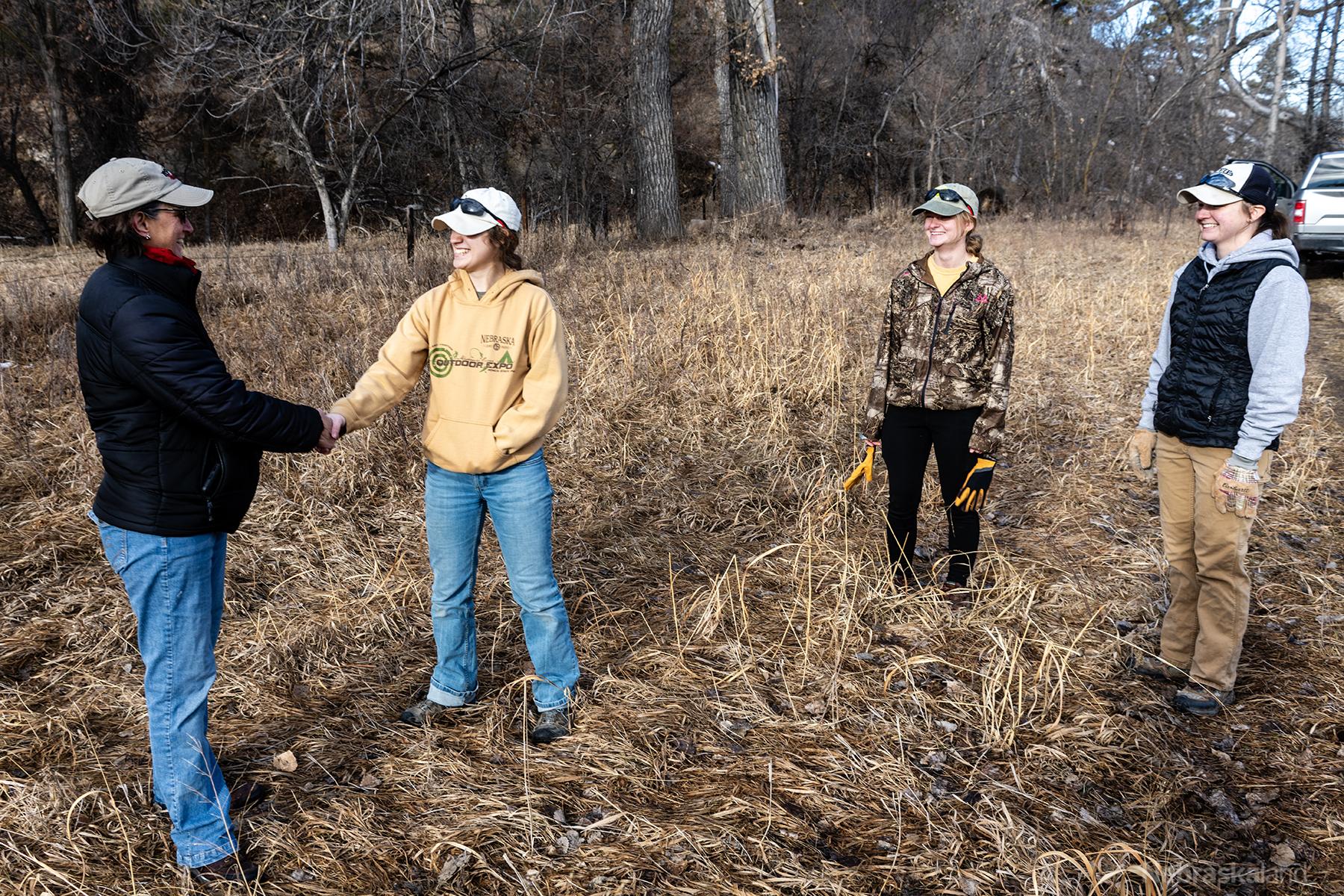 MS student Jade Wawers shakes hands with a partnering landowner