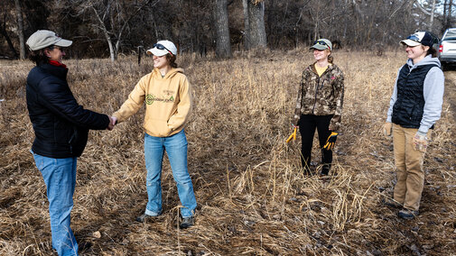 MS student Jade Wawers shakes hands with a partnering landowner