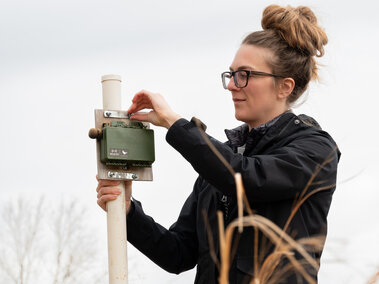 Undergraduate researcher Kol sets up an acoustic monitor